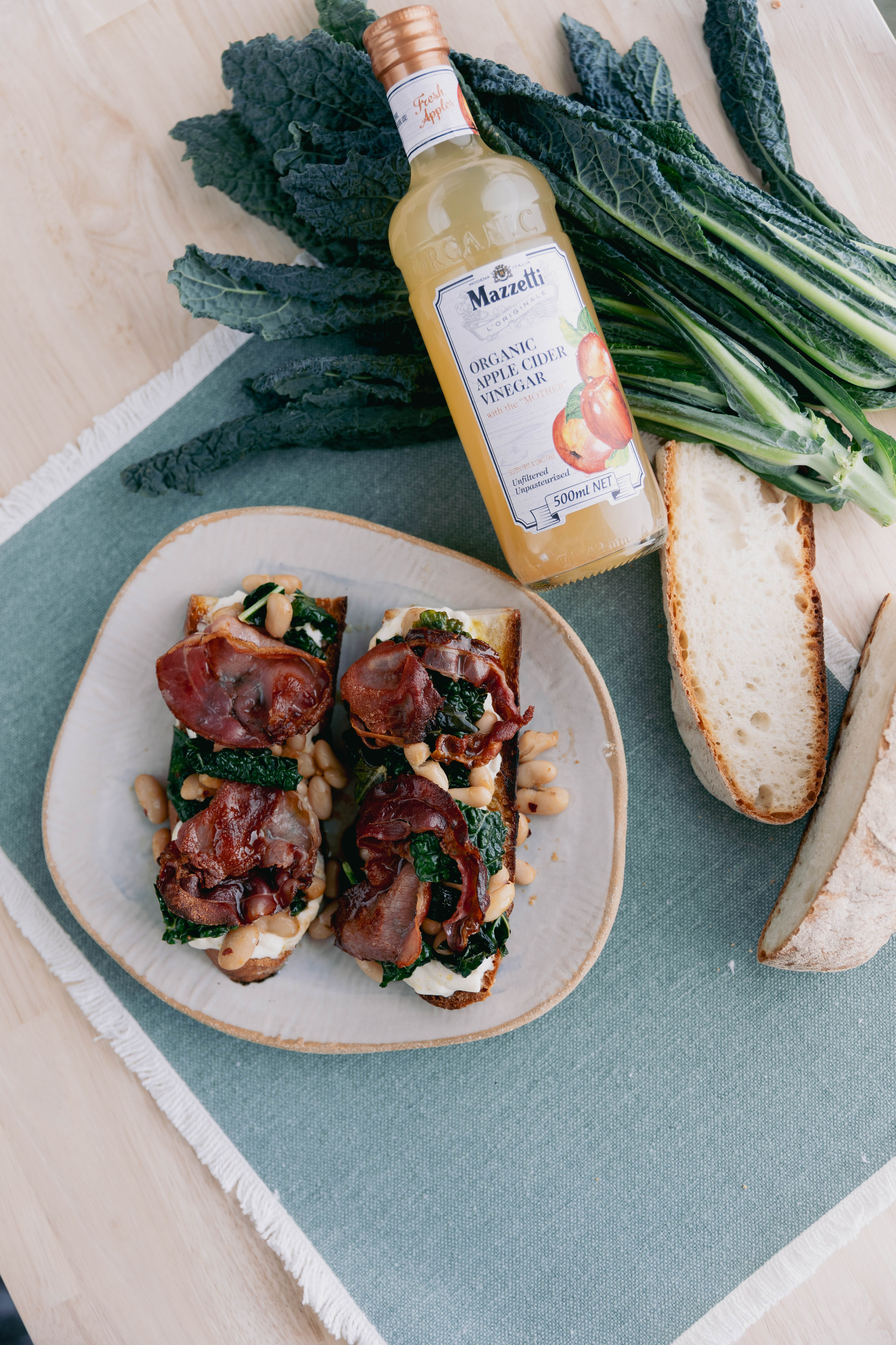 Stracciatella crostini with cavolo nero, crispy pancetta and beans